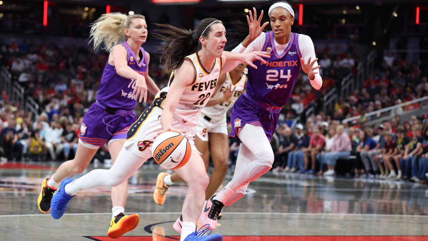 INDIANAPOLIS, INDIANA - JUNE 24: Caitlin Clark #22 of the Indiana Fever dribbles the ball against t...