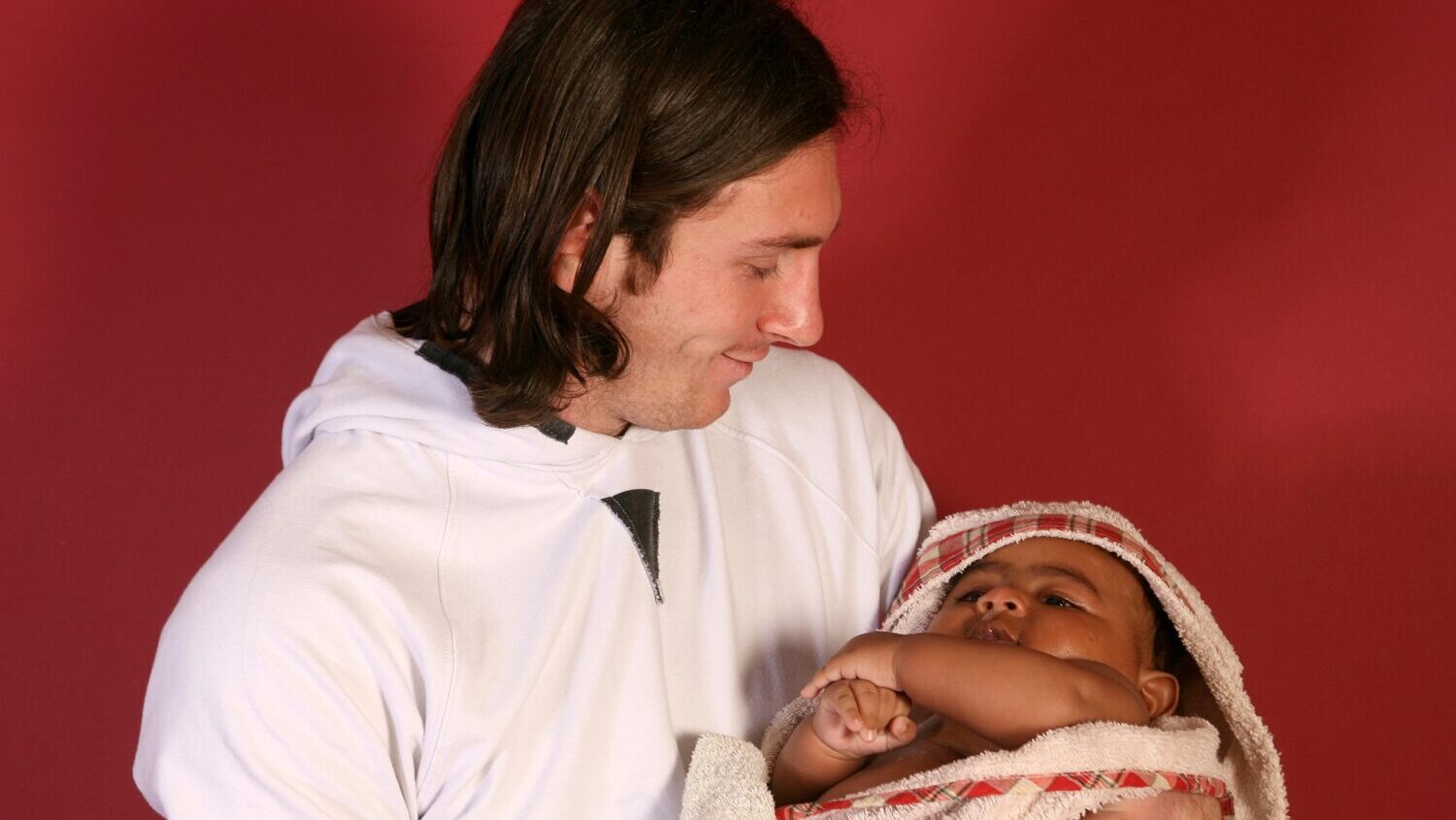20-year-old soccer star Lionel Messi cradles Lamine Yamal, who was merely six months old at the tim...