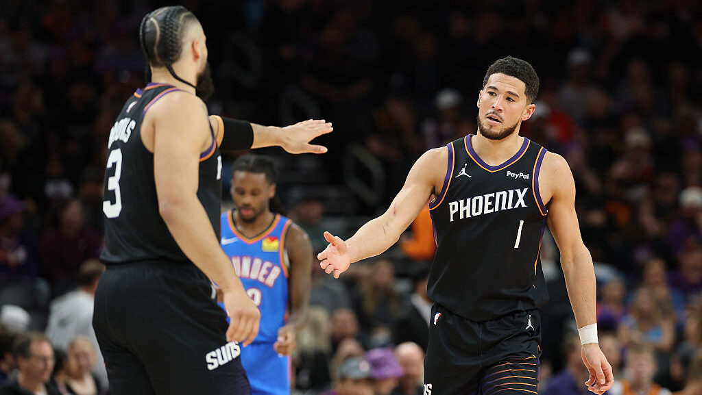 Devin Booker #1 of the Phoenix Suns high fives Dillon Brooks #3 after scoring against the Oklahoma ...
