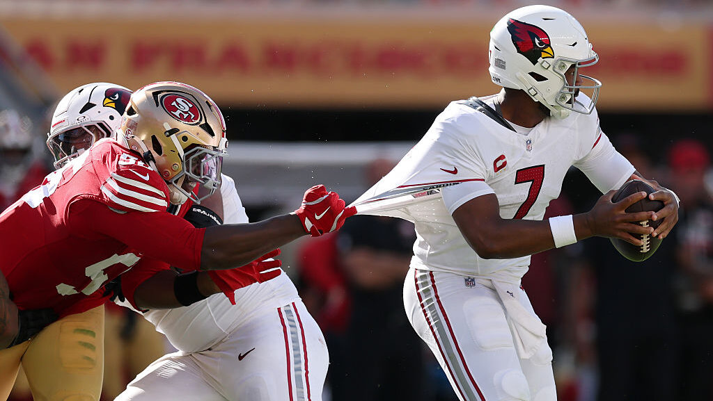 SANTA CLARA, CALIFORNIA - SEPTEMBER 27: Jacoby Brissett #7 of the Arizona Cardinals is hit by Keion...