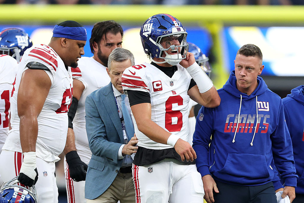Jaxson Dart #6 of the New York Giants walks off the field after a play against the Los Angeles Rams...