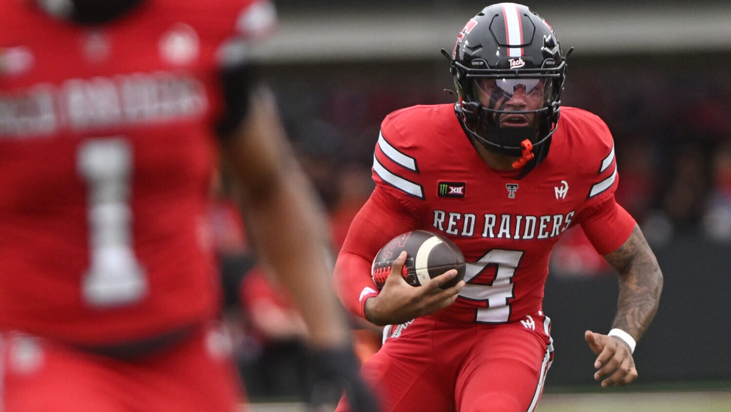 Texas Tech quarterback Tommy Castellanos (4) runs with the ball during the first half of an NCAA co...