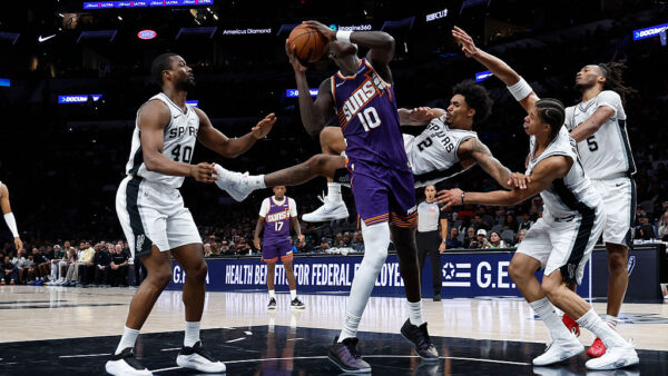 Dylan Harper #2 of the San Antonio Spurs tries to stop Khaman Maluach #10 of the Phoenix Suns from scoring