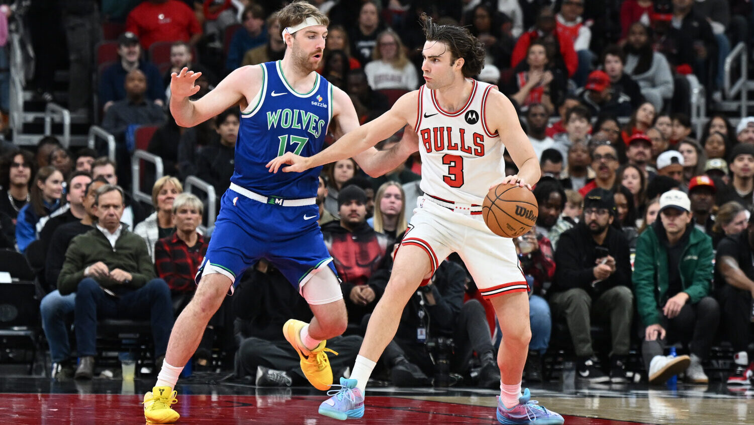 Josh Giddey #3 of the Chicago Bulls dribbles the ball as Drew Timme #17 of the Minnesota Timberwolv...