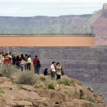 A crowd of tourists watch the rollout of the Skywalk on the Hualapai Indian Reservation in Grand Canyon West, Ariz. Organizers expect the Skywalk to become the main draw in a community of tribal attractions that includes a cowboy town, an Indian village, helicopter tours and Hummer rides through the outback. (Associated Press)
