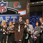 Brady Quinn, a quarterback from Notre Dame, holds a jersey while standing with family members after being selected 22nd overall by the Cleveland Browns. AP Photo/Jason DeCrow