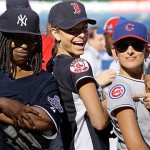 From left, comedian Whoopi Goldberg, Access Hollywood correspondent Maria Menounous and Marlee Matlin pose in their uniforms after playing in the All Star Legends & Celebrity softball game at Yankee Stadium in New York, Sunday.
