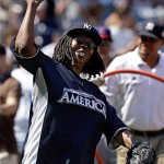 Comedian Whoopi Goldberg tosses a ball while warming up for the All Star Legends & Celebrity softball game at Yankee Stadium in New York, Sunday.