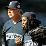 Rich "Goose" Gossage, left, embraces comedian Whoopi Goldberg during the All Star Legends & Celebrity softball game at Yankee Stadium in New York, Sunday.
