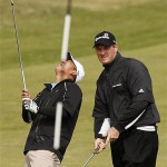 Anthony Kim of the USA, left, reacts as Todd Hamilton of the USA plays during practice for the British Open Golf championship, at the Royal Birkdale golf course, Southport, England, Wednesday, July 16, 2008. (AP Photo/Jon Super)