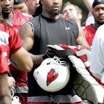 Arizona Cardinals' Darnell Dockett takes his pads off after practice during the first day of their NFL football training camp Friday, July 25, 2008 in Flagstaff, Ariz. (AP Photo/Matt York)