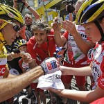 Carlos Sastre of Spain, wearing the overall leader's yellow jersey, signs autographs prior to the start of the 19th stage of the Tour de France cycling race between Roanne and Montlucon, central France, Friday.