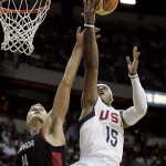 U.S. forward Carmelo Anthony (15) gets fouled by Canada forward Levon Kendall (14) during an exhibition basketball game in Las Vegas, Friday, July 25, 2008. (AP Photo/Louie Traub)