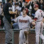 Arizona Diamondbacks' Chris Snyder, center, reacts after home plate umpire Bill Hohn, left, called him out after being tagged by San Francisco Giants catcher Bengie Molina during the fifth inning of their baseball game in San Francisco, Saturday, July 26, 2008. At right is the Diamondbacks' Stephen Drew. Snyder attempted to score from second base after the Diamondbacks' Brandon Webb singled. (AP Photo/Eric Risberg)