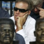 Hall of Fame quarterback John Elway is seen watching a speech by former San Diego Chargers defensive end Fred Dean at the Pro Football Hall of Fame Saturday, Aug. 2, 2008, in Canton, Ohio. (AP Photo/Mark Duncan)