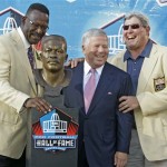 Former New England Patriots linebacker Andre Tippett, left, stands next to his bronze bust with Patriots owner Robert Kraft and 1991 inductee John Hannah, right, at the Pro Football Hall of Fame on Saturday, Aug. 2, 2008, in Canton, Ohio. (AP Photo/Kiichiro Sato)