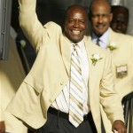 Darrell Green acknowledges fans as he is introduced at the Pro Football Hall of Fame Saturday, Aug. 2, 2008, in Canton, Ohio. (AP Photo/Mark Duncan)