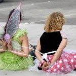 Protesters dressed as Tinker Bell and Minnie Mouse wait to be taken away after being arrested by police officers during a demonstration against Disney's treatment of hotel workers outside of Disneyland in Anaheim, Calif., on Thursday, Aug. 14, 2008. (AP Photo/Carlos Delgado)