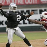 Oakland Raiders quarterback JaMarcus Russell (2) gets off a pass in front of Arizona Cardinals defensive tackle Darnell Dockett (90) in the second quarter of their preseason football game in Oakland, Calif., Saturday, Aug. 23, 2008. (AP Photo/Paul Sakuma)