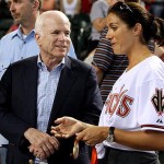 Republican presidential candidate Sen. John McCain, R-Ariz., left, talks with Olympic gold medal winner Misty May-Treanor, who is holding her medal from the 2008 Beijing Olympics, before the start of the baseball game between the Arizona Diamondbacks and the Florida Marlins Sunday, Aug. 24, 2008, in Phoenix. (AP Photo/Ross D. Franklin)