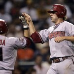 Arizona Diamondbacks' Mark Reynolds gets a high-five from teammate Augie Ojeda after scoring on a two-run single by Chris Snyder against the San Diego Padres in the fourth inning of a baseball game on Monday, Aug. 25, 2008 in San Diego. (AP Photo/Lenny Ignelzi)
