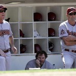 Arizona Diamondbacks manager Bob Melvin, left, Adam Dunn, center, and coach Kirk Gibson watch the ninth inning of a baseball game against the San Diego Padres, Wednesday, Aug. 27, 2008 in San Diego. The Padres won 5-4. (AP Photo/Lenny Ignelzi)