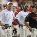 Nebraska head coach Bo Pelini, left, yells instructions to his team with his brother, Carl Pelini, right, Nebraska's defensive coordinator, looking on during a college football game against Western Michigan, in Lincoln, Neb., Saturday, Aug. 30, 2008, Nebraska defeated Western Michigan 47-24.(AP Photo/Dave Weaver)