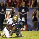 Arizona's Mike Thomas (10) fumbles the ball after being tackled by Idaho's Eric Hunter (4) during the second quarter of college football in Arizona Stadium in Tucson, Ariz., Saturday, Aug. 30, 2008 (AP Photo/John Miller)