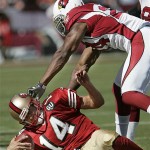 San Francisco 49ers quarterback J.T. O'Sullivan (14) is pushed out of bounds by Arizona Cardinals safety Adrian Wilson (24) in the third quarter of an NFL football game in San Francisco, Sunday, Sept. 7, 2008. The Arizona Cardinals defeated the San Francisco 49ers 23-13.(AP Photo/Paul Sakuma)
