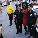 US Open women's singles tennis champion Serena Williams poses with police officers Chris Vital, right, and Carissa Gonzalez in New York's Times Square on Monday Sept. 8, 2008. (AP Photo/Brian McDermott)