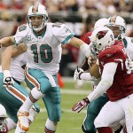 Miami Dolphins' Chad Pennington (10) tries to get away from Arizona Cardinals' Bertrand Berry, right, as Dolphins' Justin Smiley, back right, attempts to block Berry in the first quarter of a football game Sunday, Sept. 14, 2008, in Glendale, Ariz. (AP Photo/Ross D. Franklin)