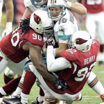 Miami Dolphins quarterback Chad Pennington (10) gets sacked by Arizona Cardinals' Bertrand Berry (92) and Darnell Dockett (90) during the fourth quarter of an NFL football game Sunday, Sept. 14, 2008, in Glendale, Ariz. The Cardinals won 31-10. (AP Photo/Matt York)