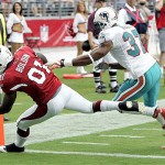 Arizona Cardinals wide receiver Anquan Boldin (81) scores his second touchdown of the day as Miami Dophins' Yeremiah Bell (37) defends during the first quarter of an NFL football game Sunday, Sept. 14, 2008 in Glendale, Ariz. (AP Photo/Matt York)