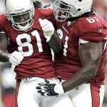 Arizona Cardinals' Elton Brown (61) celebrates with teammate Anquan Boldin (81) after Bolding scored his third touchdown of the day against the Miami Dolphins during the fourth quarter of an NFL football game Sunday, Sept. 14, 2008 in Glendale, Ariz. The Cardinals won 31-10. (AP Photo/Matt York)