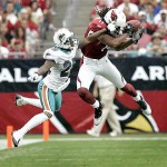 Arizona Cardinals wide receiver Larry Fitzgerald, right, pulls in a pass as Miami Dophins' Will Allen defends during the first quarter of their NFL football game Sunday, Sept. 14, 2008 in Glendale, Ariz. (AP Photo/Matt York)