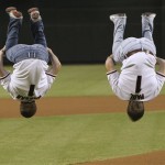 After throwing out the first pitch Paul Hamm, right, and twin brother Morgan Hamm, both members of the U.S. gymnastics team, do back flips prior to the baseball game between the San Francisco Giants and the Arizona Diamondbacks Thursday, Sept. 18, 2008, in Phoenix. Several members of the United States gymnastics team were on hand for the game. (AP Photo/Ross D. Franklin)