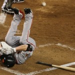 San Francisco Giants' Tim Lincecum falls to the ground after fouling off a pitch from Arizona Diamondbacks' Randy Johnson on an attempted bunt in the fifth inning of a baseball game Thursday, Sept. 18, 2008, in Phoenix. (AP Photo/Ross D. Franklin)