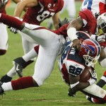 Buffalo Bills' Leodis McKelvin (28) gets tackled by Arizona Cardinals' Ali Highsmith, top, on a kickoff return in the fourth quarter of a football game Sunday, Oct. 5, 2008, in Glendale, Ariz. The Cardinals won 41-17. (AP Photo/Ross D. Franklin)