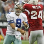 Dallas Cowboys' Tony Romo (9) gets a pass off around Arizona Cardinals' Adrian Wilson (24) in the second quarter of an NFL football game Sunday, Oct. 12, 2008, in Glendale, Ariz. (AP Photo/Ross D. Franklin)
