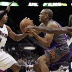 Phoenix Suns forward Grant Hill drives through the lane guarded by Atlanta Hawks guard Maurice Evans (1) and guard Mario West (6) during the first half of an NBA preseason basketball game, Wednesday Oct. 15, 2008, in Atlanta. (AP Photo/John Amis)
