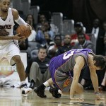 Phoenix Suns guard Steve Nash goes down to the floor as Atlanta Hawks guard Acie Law comes up with the ball after a Nash jump shot in which he sprained his ankle during the first half of an NBA preseason basketball game, Wednesday Oct. 15, 2008, in Atlanta. (AP Photo/John Amis)