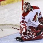 Phoenix Coyotes' Ilya Bryzgalov looks back at the puck after being scored on by Ottawa Senators' Dany Heatley during first-period NHL hockey action at the Scotiabank Place in Ottawa, Canada, on Friday, Oct. 17, 2008. (AP Photo/The Canadian Press,Sean Kilpatrick)
