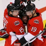 Ottawa Senators' Jason Spezza, right, and Daniel Alfredsson, middle, celebrate with teammate Dany Heatley after his goal against the Phoenix Coyotes during first-period NHL hockey action at the Scotiabank Place in Ottawa, Ontario, on Friday, Oct. 17, 2008. (AP Photo/The Canadian Press,Sean Kilpatrick)