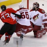 Ottawa Senators' Jarkko Ruutu, left, puts the puck past Phoenix Coyotes' Ilya Bryzgalov, right, as Coyotes' Ed Jovanovski tries to defend during first-period NHL hockey action at the Scotiabank Place in Ottawa, Ontario, on Friday, Oct. 17, 2008. (AP Photo/The Canadian Press,Sean Kilpatrick)