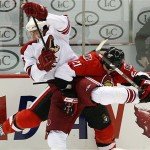 Ottawa Senators' Jason Smith, right, gets hit by Phoenix Coyotes' Enver Lisin during period third-period NHL hockey action at the Scotiabank Place in Ottawa, Ontario, on Friday, Oct. 17, 2008. The Senators defeated the Coyotes 6-3. (AP Photo/The Canadian Press,Sean Kilpatrick)