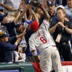 Philadelphia Phillies first baseman Ryan Howard reaches into the crowd to catch a paop foul by Tampa Bay Rays' B.J. Upton to end the fifth inning of Game 1 of the baseball World Series in St. Petersburg, Fla., Wednesday, Oct. 22, 2008. (AP Photo/Mike Carlson)
