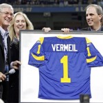 Former St. Louis Rams head coach Dick Vermeil, left, is presented with a Rams jersey by team owners Chip Rosenbloom, right, and his sister Lucia Rodriguez during a ceremony adding Vermeil's name to the team's "Ring of Honor" during halftime of an NFL football game against the St. Louis Rams and Arizona Cardinals, Sunday, Nov. 2, 2008, in St. Louis. (AP Photo/Tom Gannam)