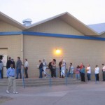 Dozens of voters wait in line at approximately 6:45 a.m. at the Powell Swimming Pool polling station on 8th Avenue in Mesa. (Kevin Tripp/KTAR)

