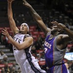New Jersey Nets' Josh Boone, left, puts up a shot as he is guarded by Phoenix Suns' Shaquille O'Neal during the second quarter of an NBA basketball game Tuesday night, Nov. 4, 2008, in East Rutherford, N.J. (AP Photo/Bill Kostroun)