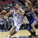 New Jersey Nets' Brook Lopez, left, drives to the basket as he is guarded by his twin brother Phoenix Suns' Robin Lopez during the second quarter of an NBA basketball game Tuesday, Nov. 4, 2008 in East Rutherford, N.J. (AP Photo/Bill Kostroun)